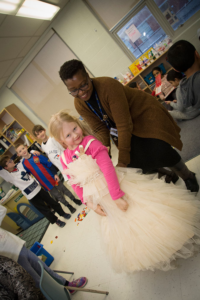 A child tries on a dress in a PLASP program