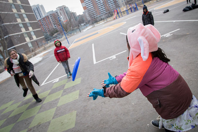 PLASP staff and children play with a frisbee