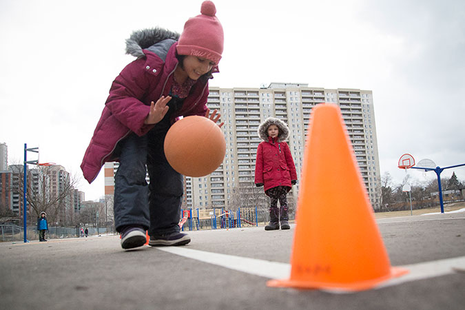 A child dribbles a basketball